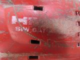 a close up of a red baseball helmet with a hole in it