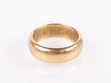 an 18k gold wedding ring with a domed design