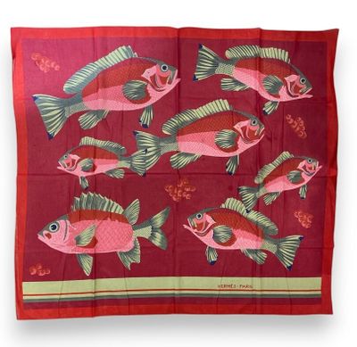 a red scarf with fish and flowers on it