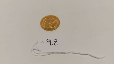 a small gold coin with a price tag on it