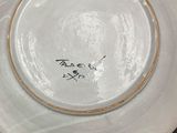 a white plate with writing on it sitting on a table