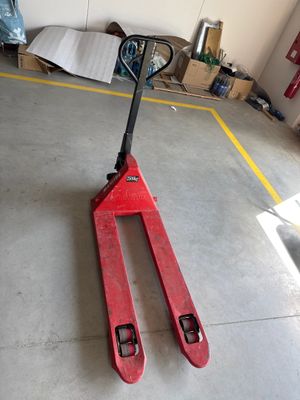 a fork lifter sitting on the floor in a garage