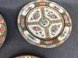 three plates with designs on them sitting on a table