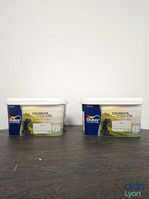 two tubs of yogurt sitting on top of a wooden table