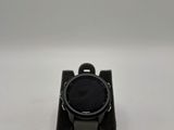 a close up of a watch sitting on top of a white surface