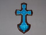 a blue cross hanging on the wall of a church
