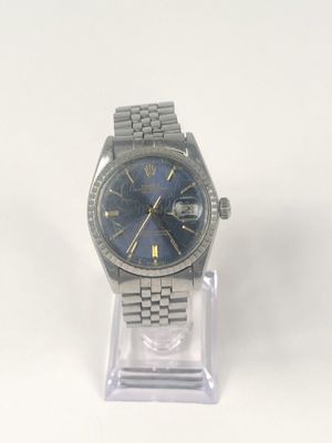 an image of a watch with a blue face on a clear stand