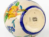 a blue and white vase with a flower design on it
