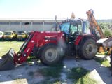 a red tractor that is parked in the grass