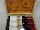 three bottles of wine in a wooden case