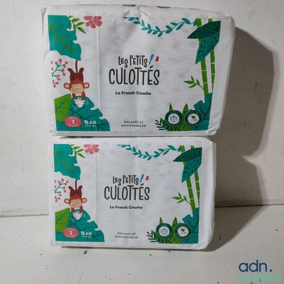 two boxes of baby wipes sitting on top of a table