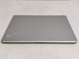 the laptop is sitting on a white surface with a white background