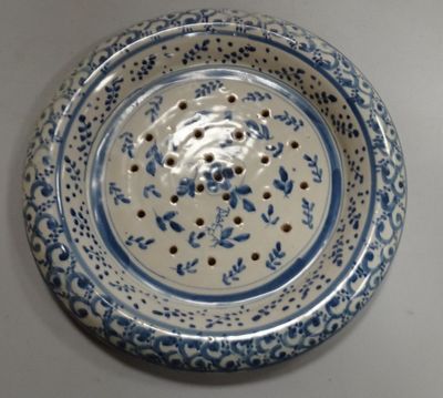 a blue and white plate with a flower design on it