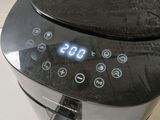 a digital clock on the side of an air fryer