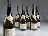 six bottles of wine sitting next to each other on a table