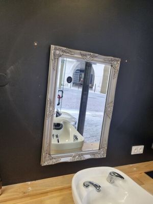 a bathroom with a sink and a mirror on the wall