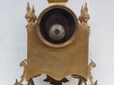 a clock that is sitting on a stand with a clock on it