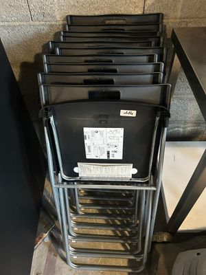 a lot of chairs that are stacked on top of each other