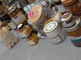 many different types of jams and condiments on the table