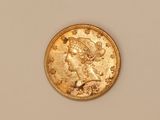 a close up of a gold coin with a woman ' s head on it