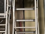 two ladders that are next to each other in a garage