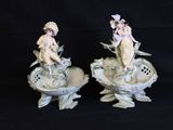 two figurines that are sitting on top of each other