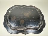 a metal tray with a handle on a table