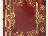 an old red book with gold trim and a decorative design on it
