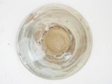 a close up of a white bowl with a brown center