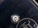 a single diamond in the middle of a clear box