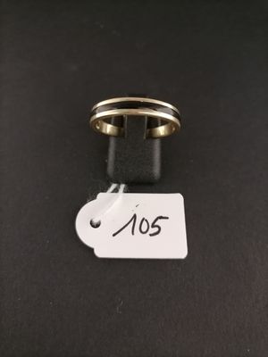 a close up of a ring on a black surface with a tag