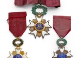 three medals and a ribbon with a star on top of it