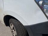 a white van that is parked on the side of the road