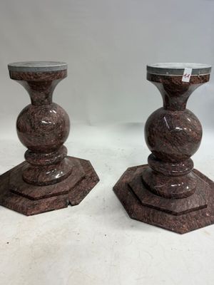 pair of brown marble pedestals with a marble top