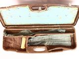 an open suitcase with an umbrella and other items in it