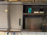 a stainless steel cabinet in the middle of a kitchen