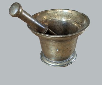 a metal mortar and a wooden pestor in it