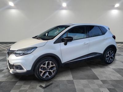 a white renault c - hr suv parked on a checkered floor