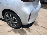 the rear end of a silver car parked in a parking lot