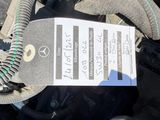 a close up of a car ' s engine with a tag attached to it