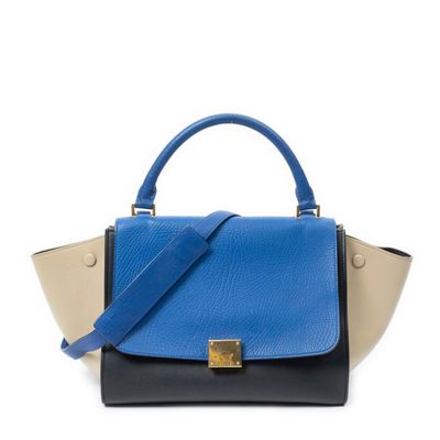 a blue and black handbag on a white background