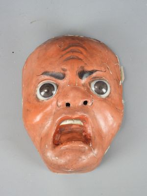 a clay mask with a face that looks like a man ' s face