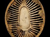 an image of a gold plate with a face in the center
