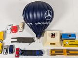 a hot air balloon, a car, a truck, a train, and other toy vehicles