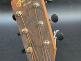 a close up of the headstock of an acoustic guitar