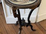 une petite table posée sur un plancher en bois, sur laquelle se trouve un bol