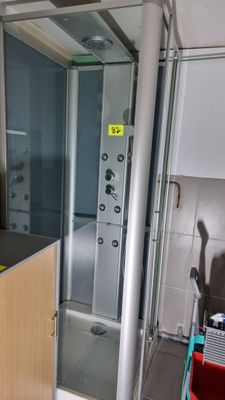 a bathroom with a shower and a sink in it