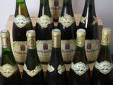 many bottles of wine that are sitting on a table