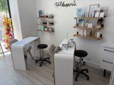 a photo of a salon with a desk, chairs, and shelves