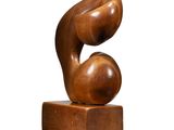 a wooden sculpture of a man and a woman on a block